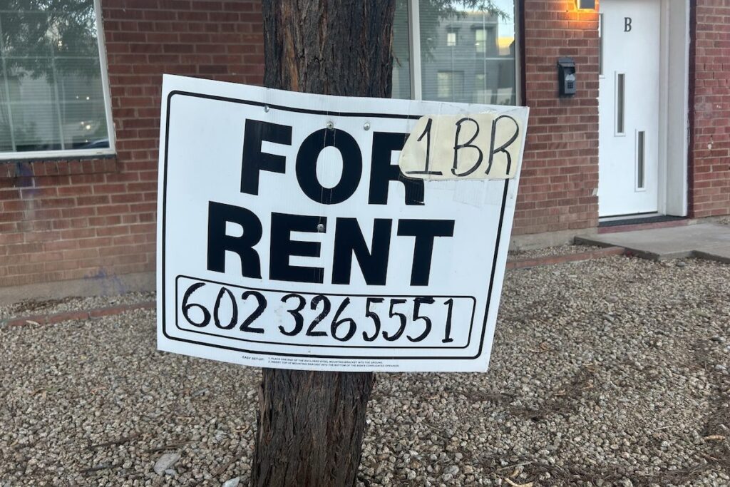 a sign that says for rent, 1 bedroom, and a phone number posted to a pole
