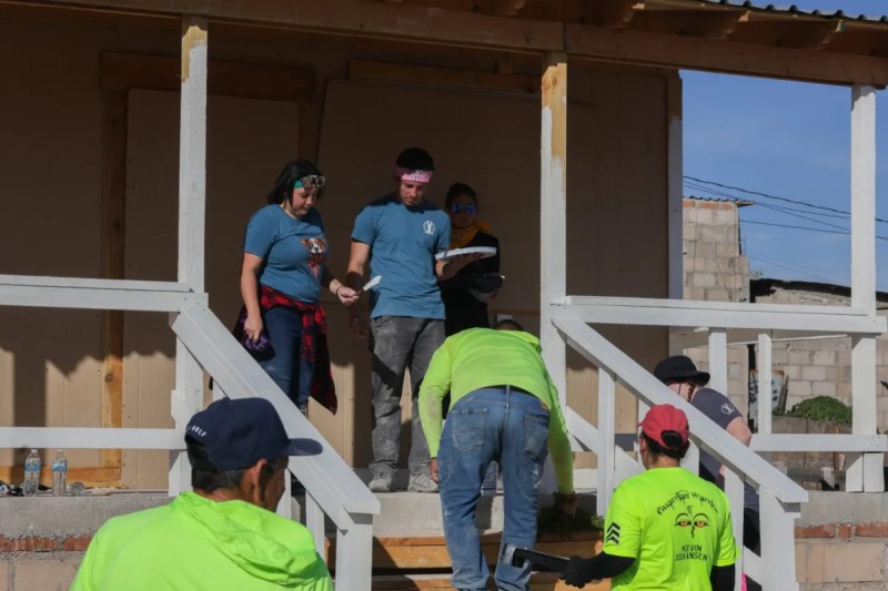 volunteers on the steps of a home being constructed