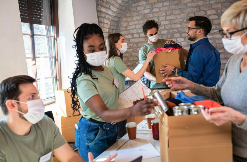 people packing boxes with cans