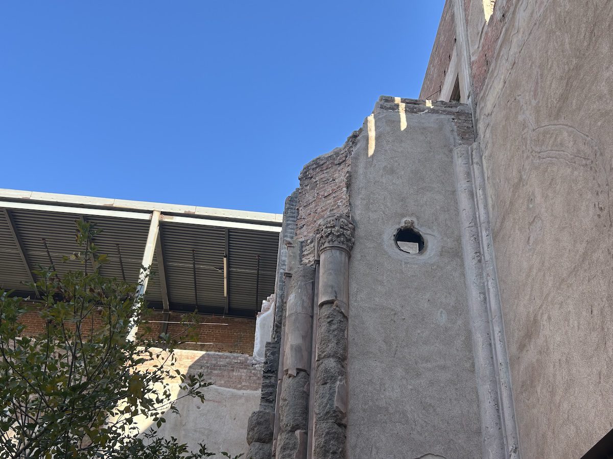 inside of a courtyard showing a brick column