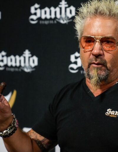 Guy Fieri holding a cigar