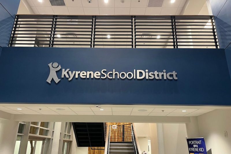 a sign that says Kyrene School District on a wall between two floors