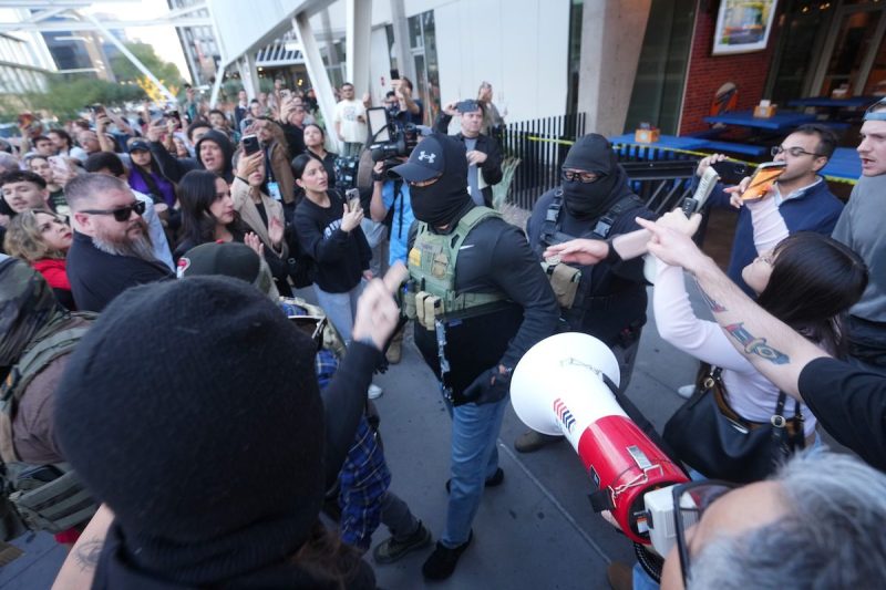 protestors gathered around federal agents