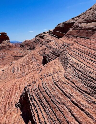 hiking trail on side of a big hill with wave-like formations