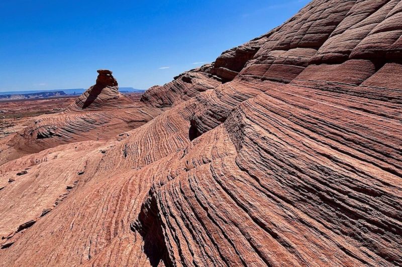 hiking trail on side of a big hill with wave-like formations