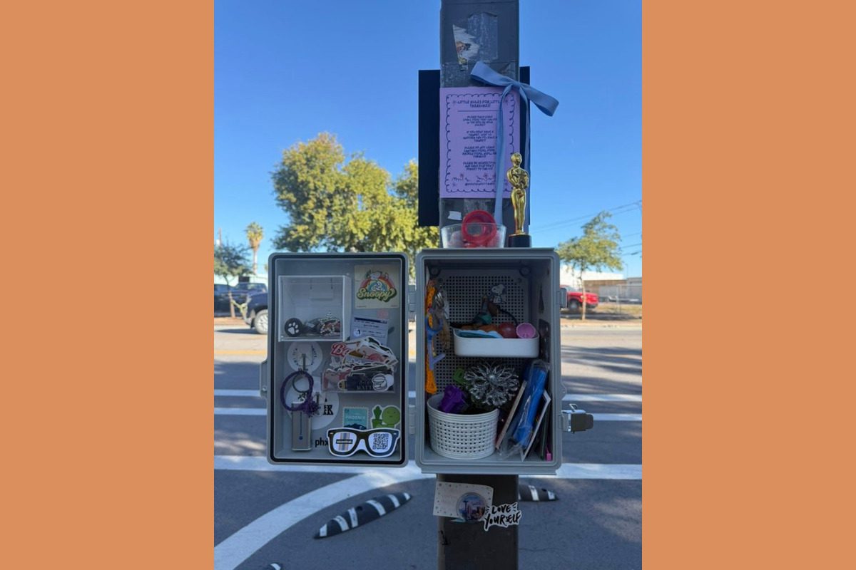 a small box on a pole filled with small trinkets