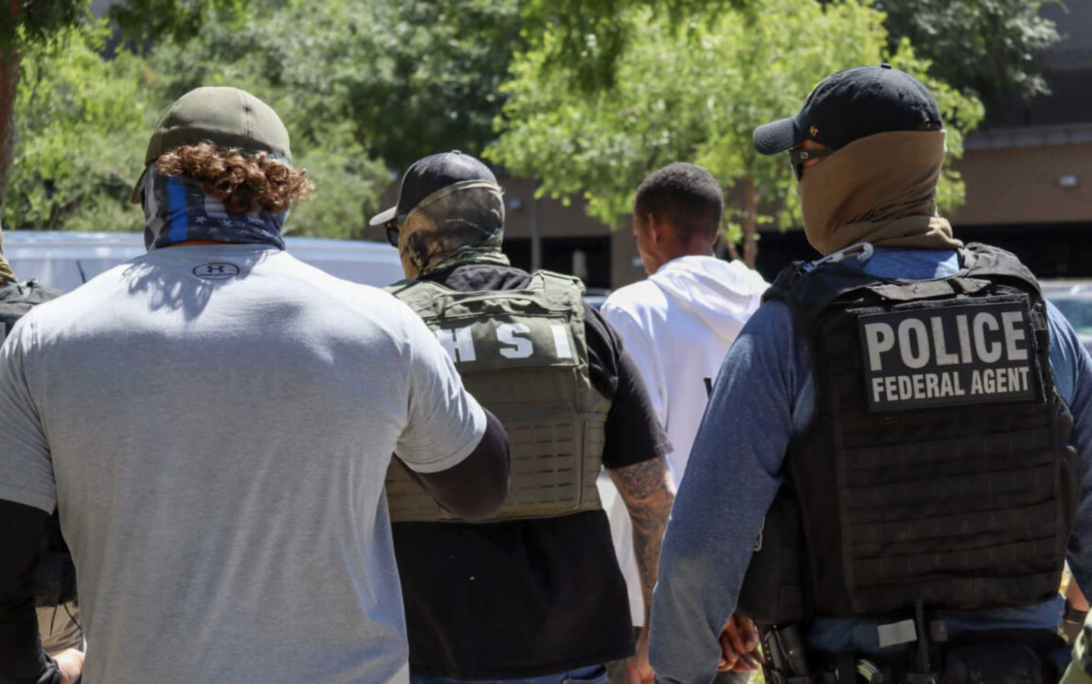 a group of masked agents