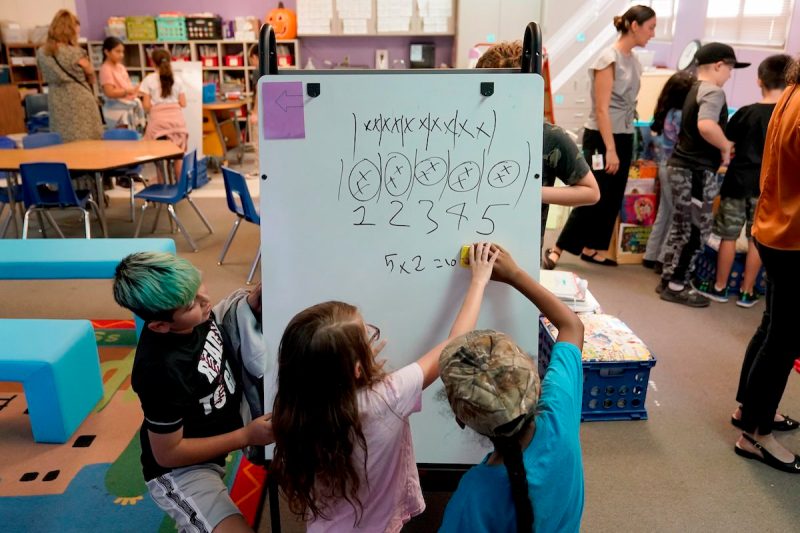 students drawing on white board