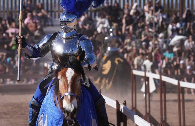 person dressed as a knight riding on a horse