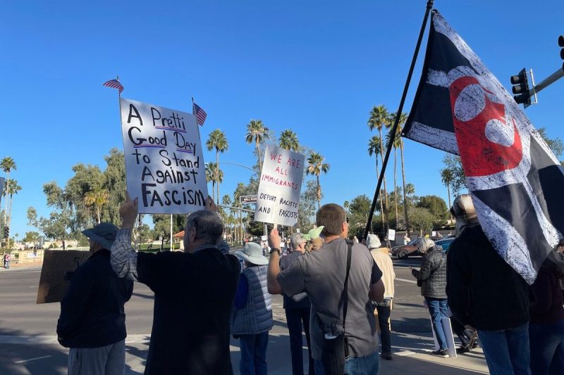people walking with anti-ICE signs