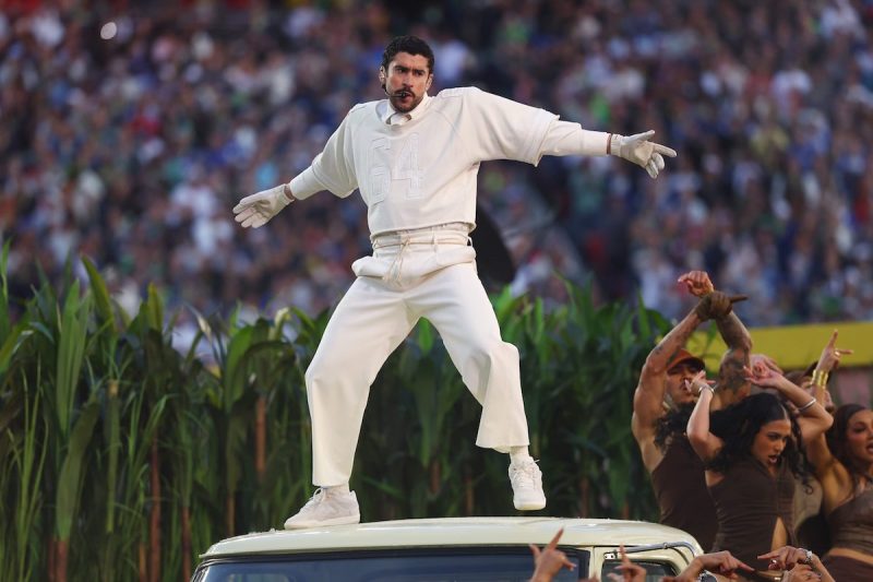 Bad Bunny standing on top of a car