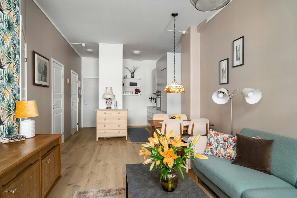 inside of an apartment with a couch, coffee table, and set of drawers