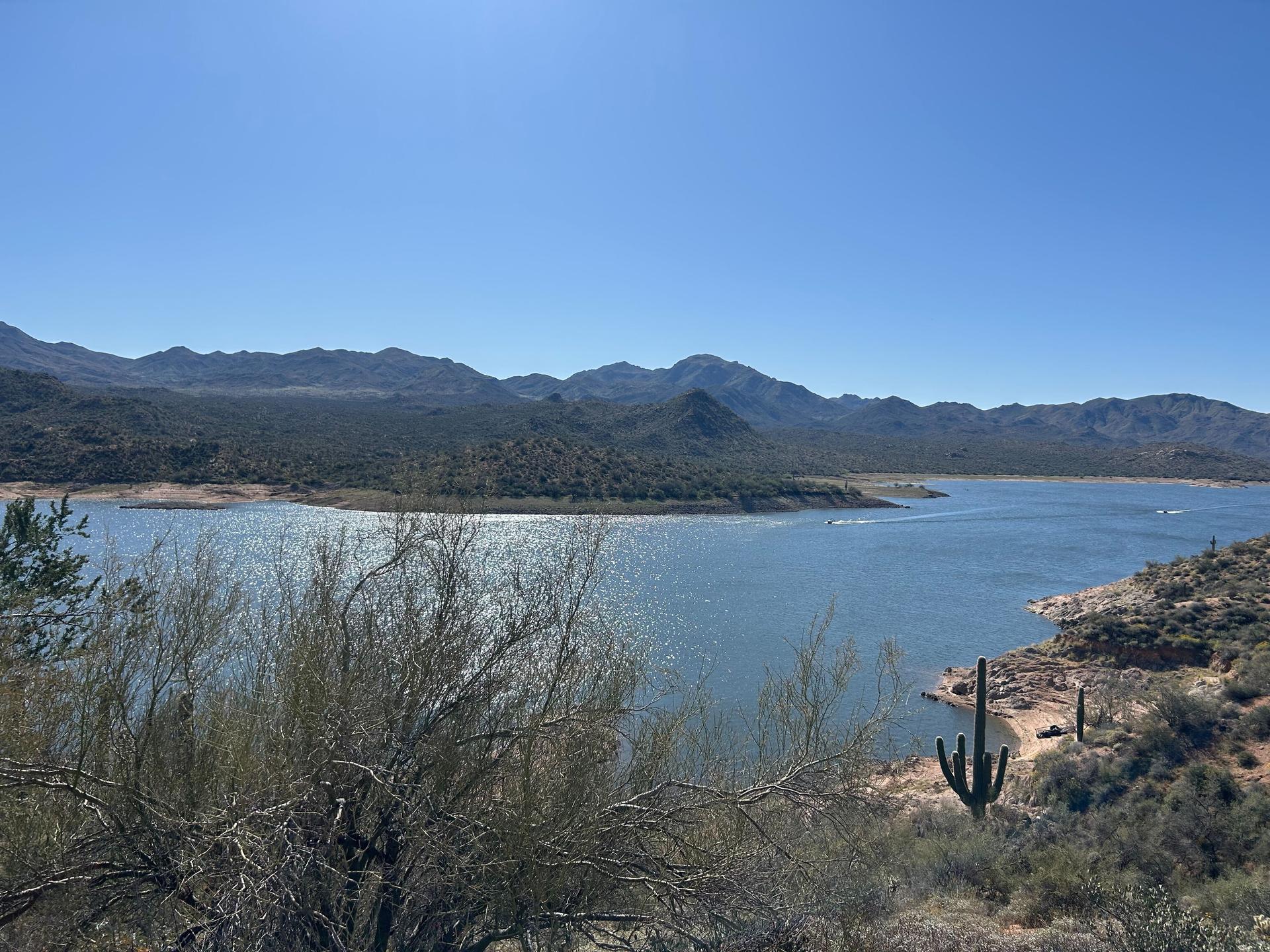 view of a lake, mountains, and desert landscape