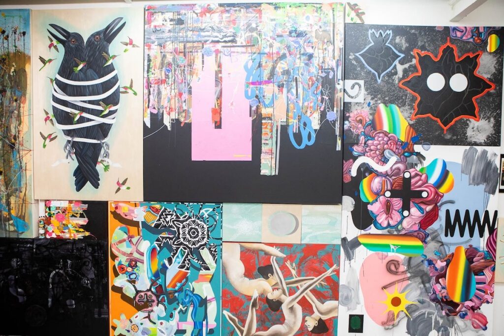 multiple canvases with art displayed on a wall