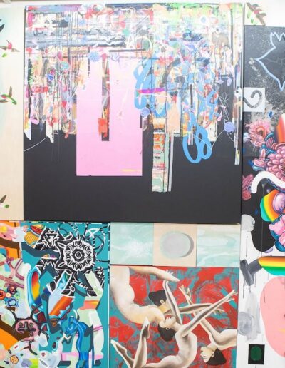 multiple canvases with art displayed on a wall