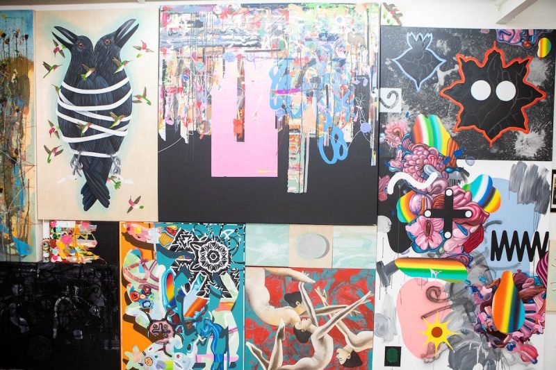 multiple canvases with art displayed on a wall