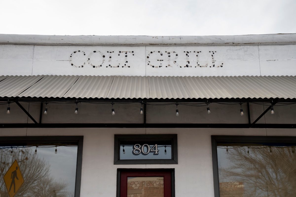the outline of letters spelling Colt Grill on a building facade