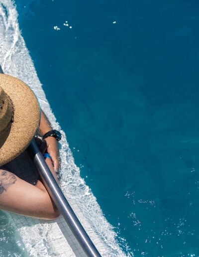 aerial view of a man lying against a railing in a pool