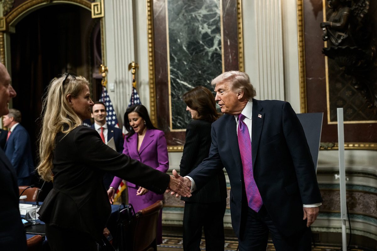 Trump shaking hands with a woman