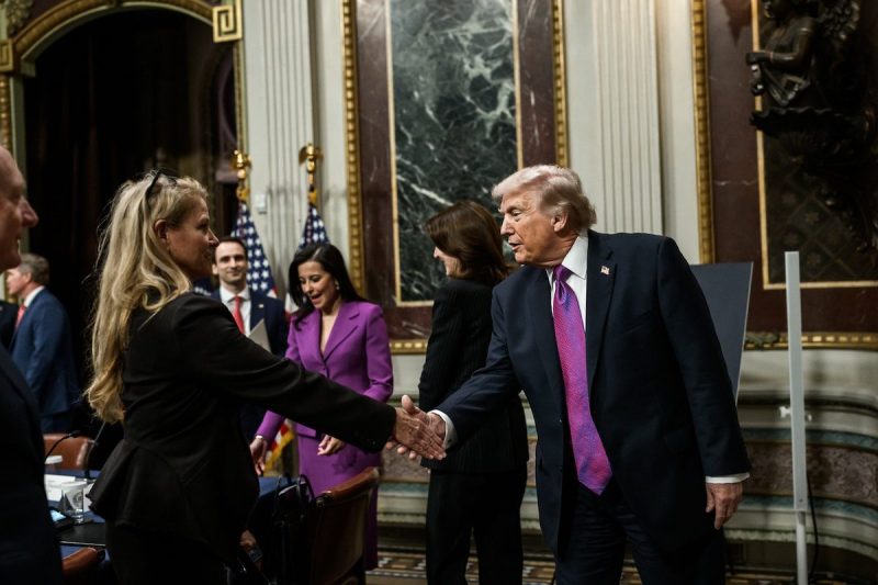 Trump shaking hands with a woman