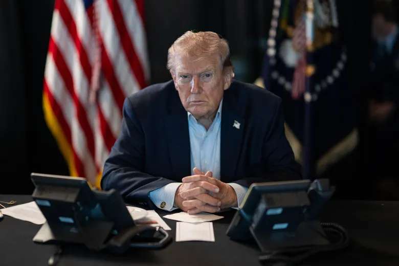 Trump seated at desk
