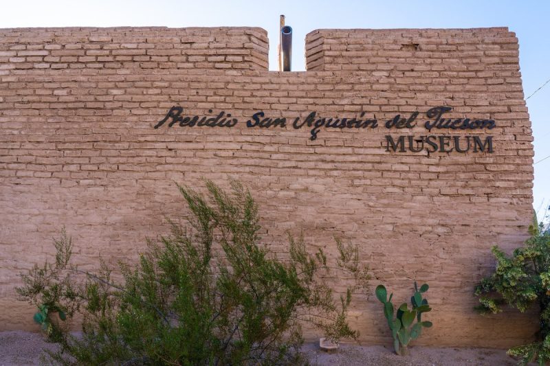 sign on brick wall that says Presidio San Agustín del Tucson Museum