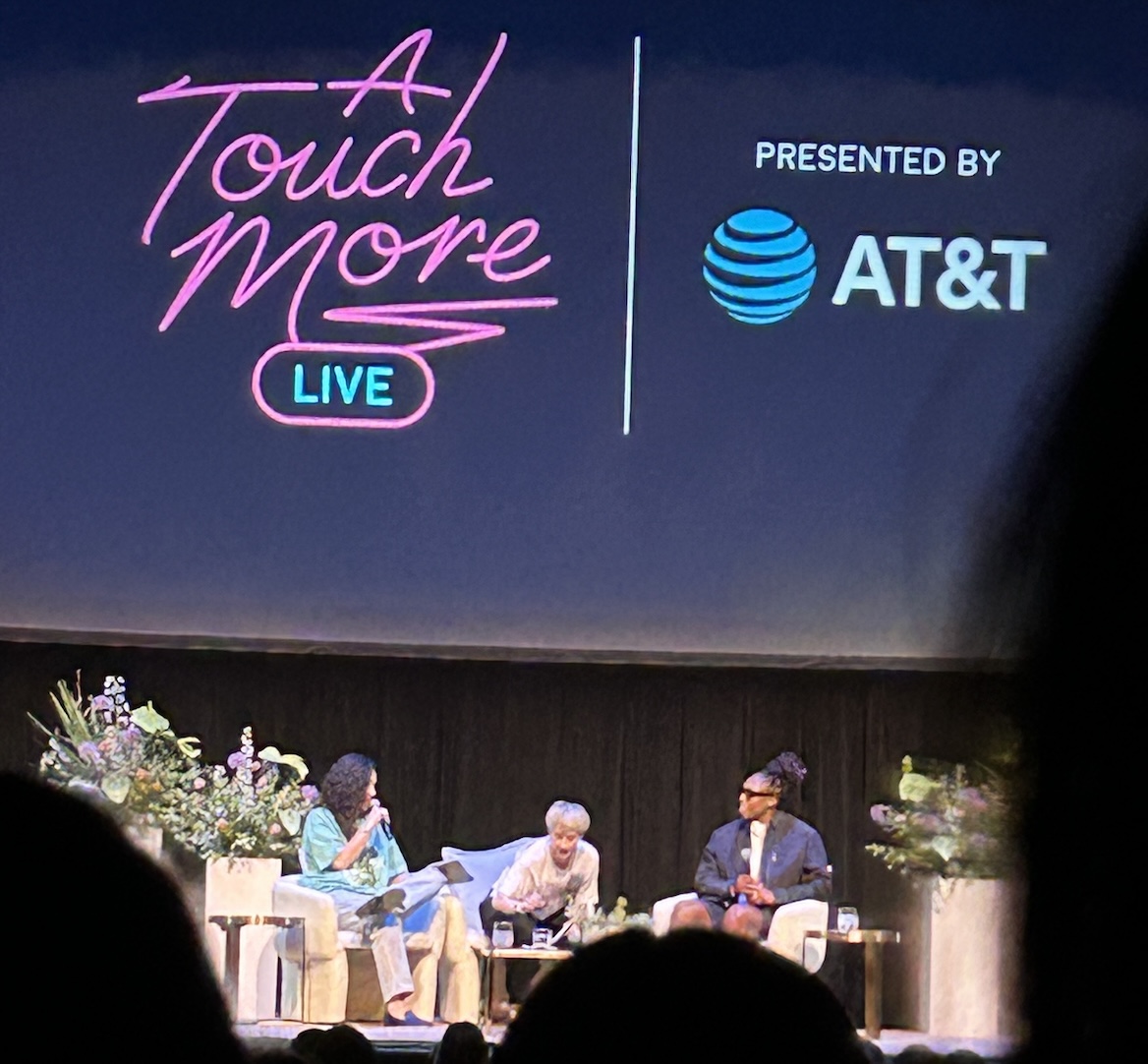 three women sitting on a stage