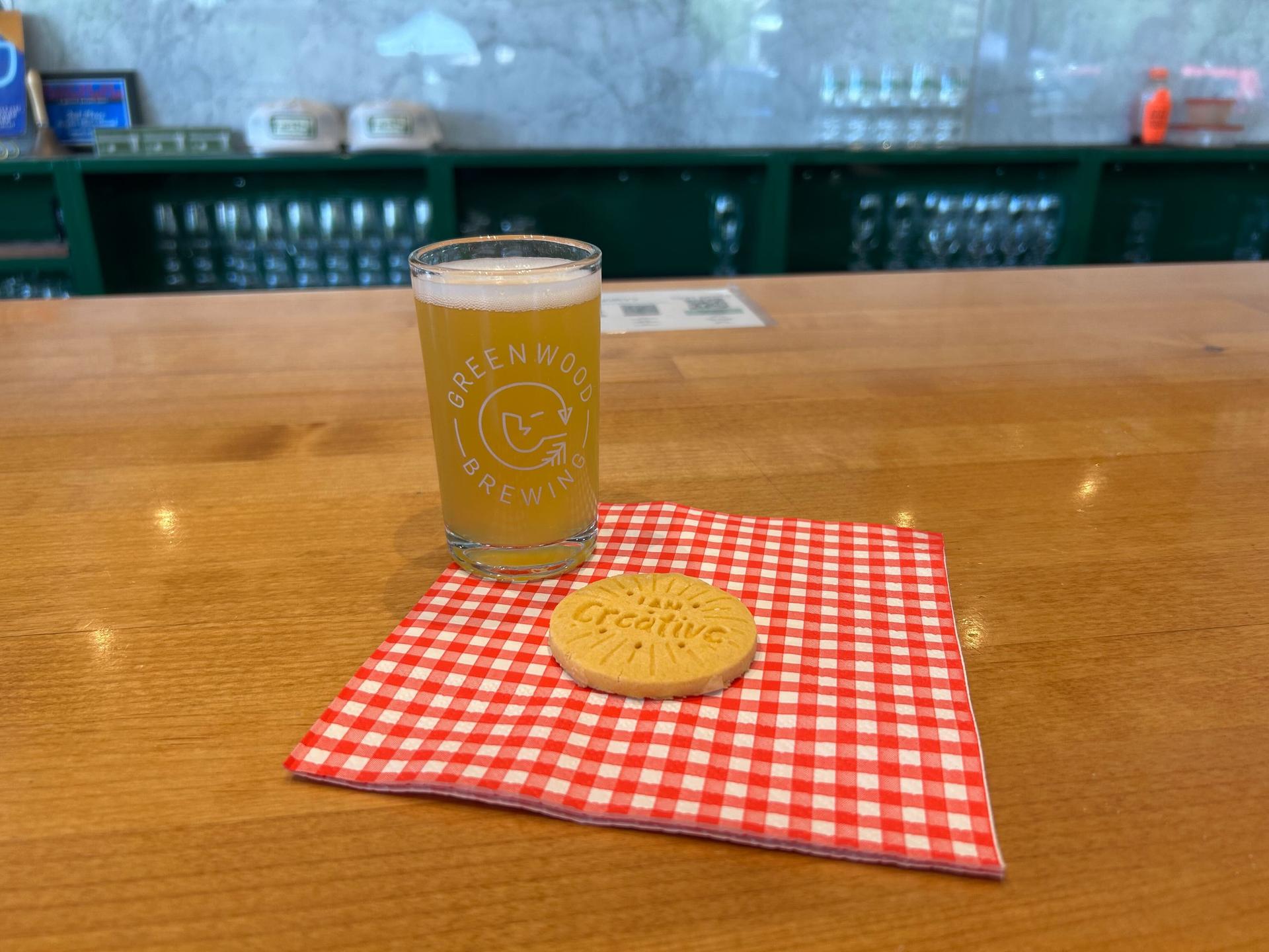  glass of beer and a cookie on a checkered napkin on a barter