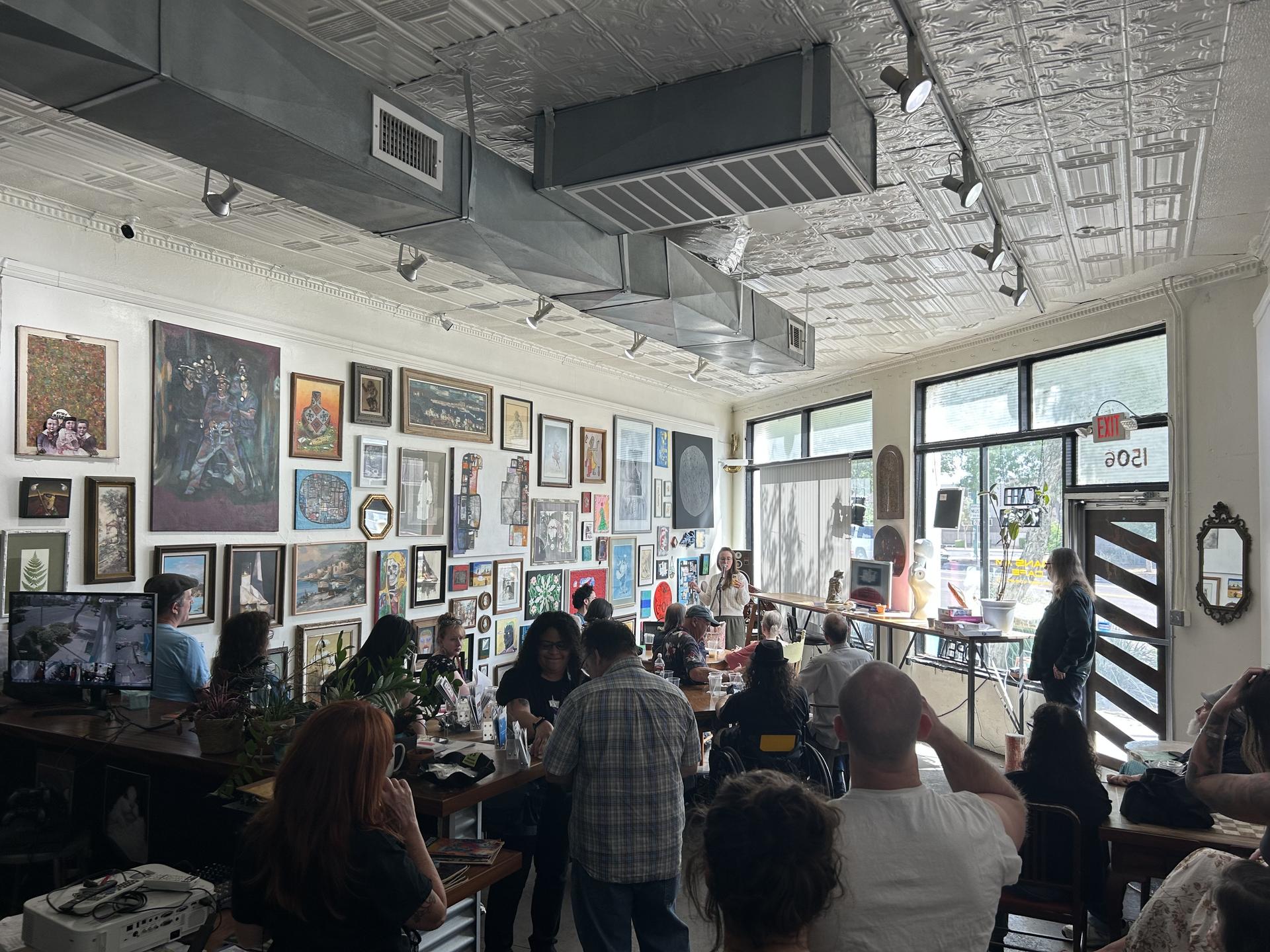 inside of a coffee shop where people are gathered 