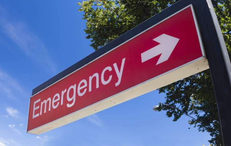 red sign that says emergency with an arrow pointing sideways