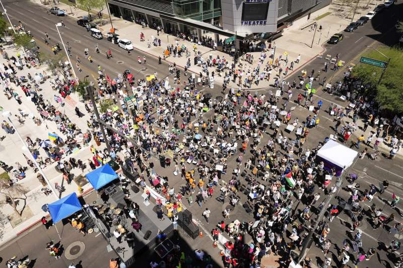 aerial shot of a large group of people protesting in an intersection