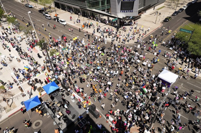 aerial shot of a large group of people protesting in an intersection