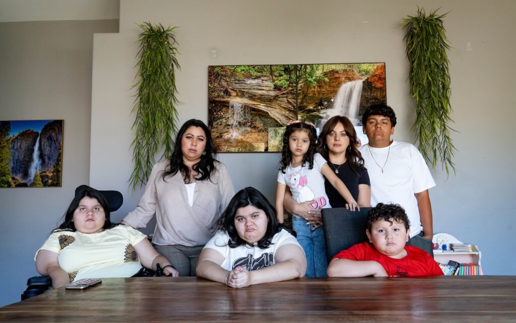 a family of women and children posing at a table