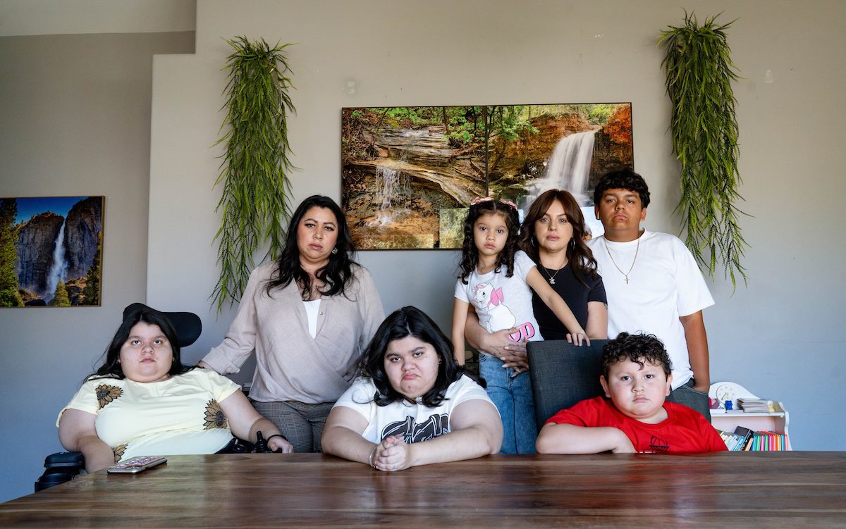 a family of women and children posing at a table