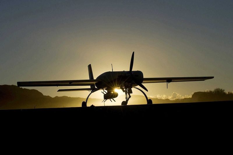the silhouette of a missile plane in front of a sunset