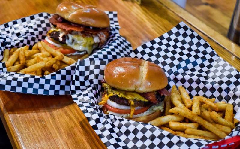 two trays of cheeseburgers and French fries