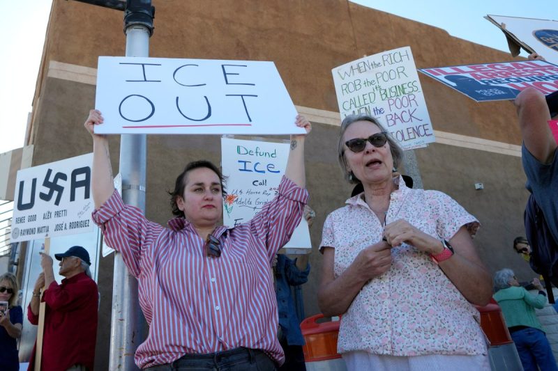 people protesting with anti-ICE signs
