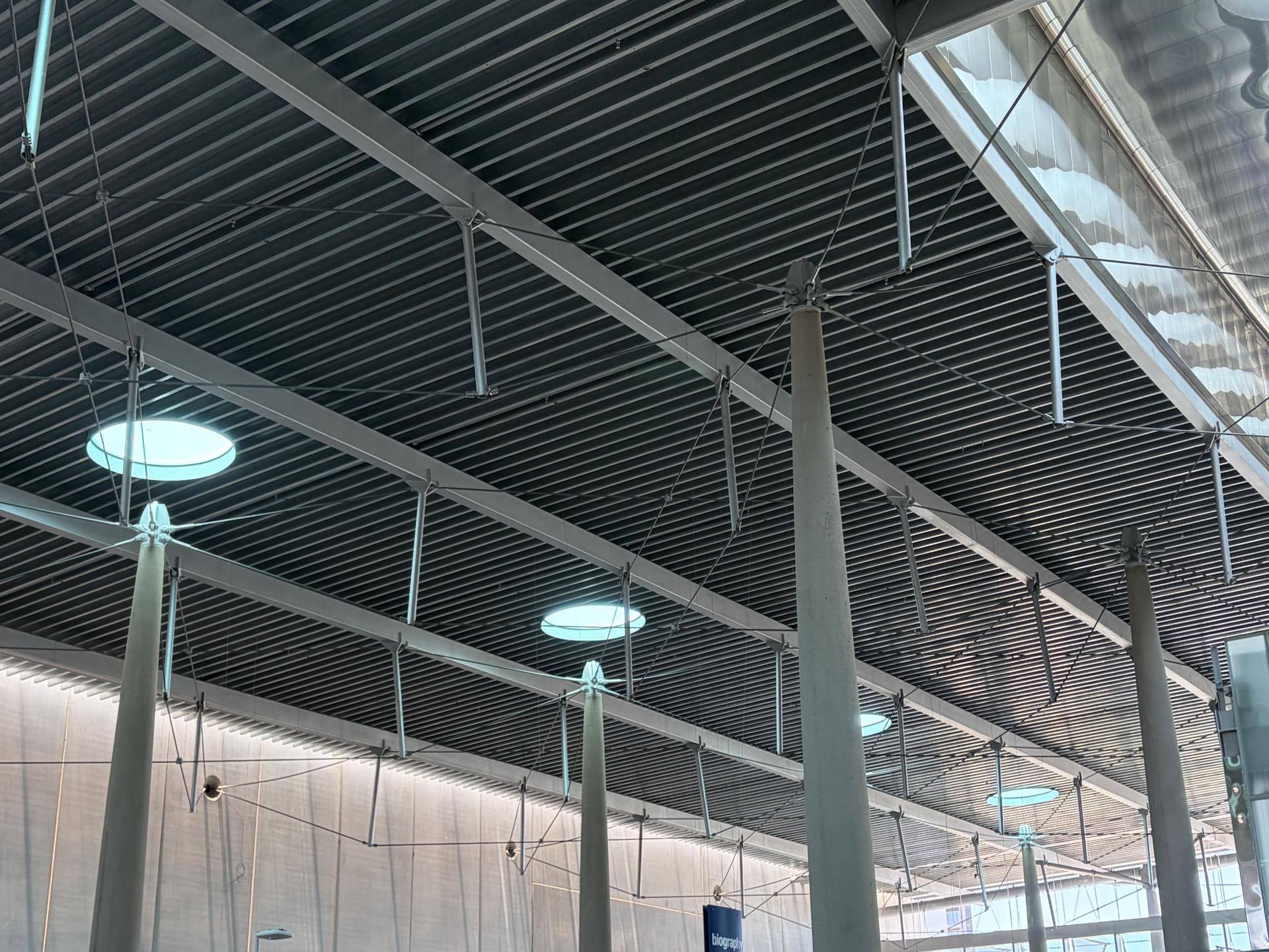 a roof with columns and skylights where light is coming through the skylights on top of the columns