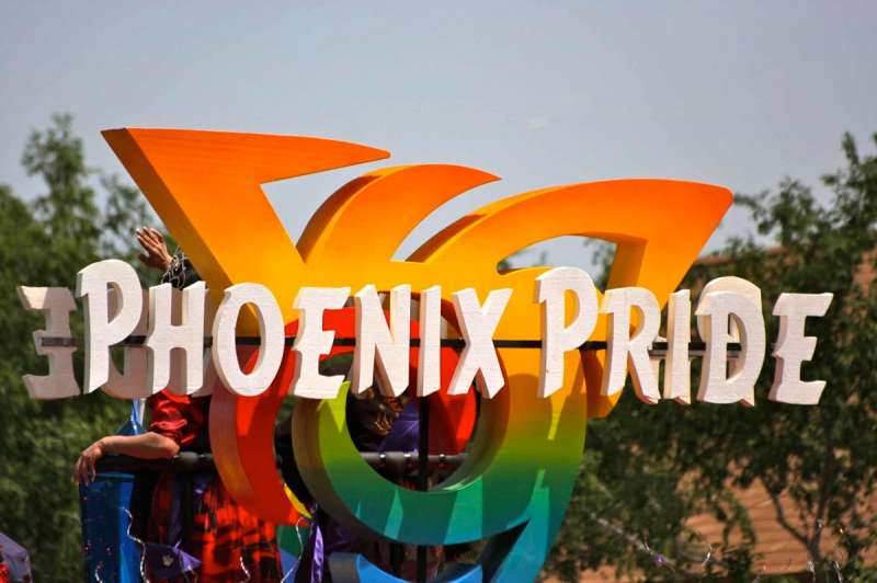 A colorful sign on a parade float for Phoenix Pride