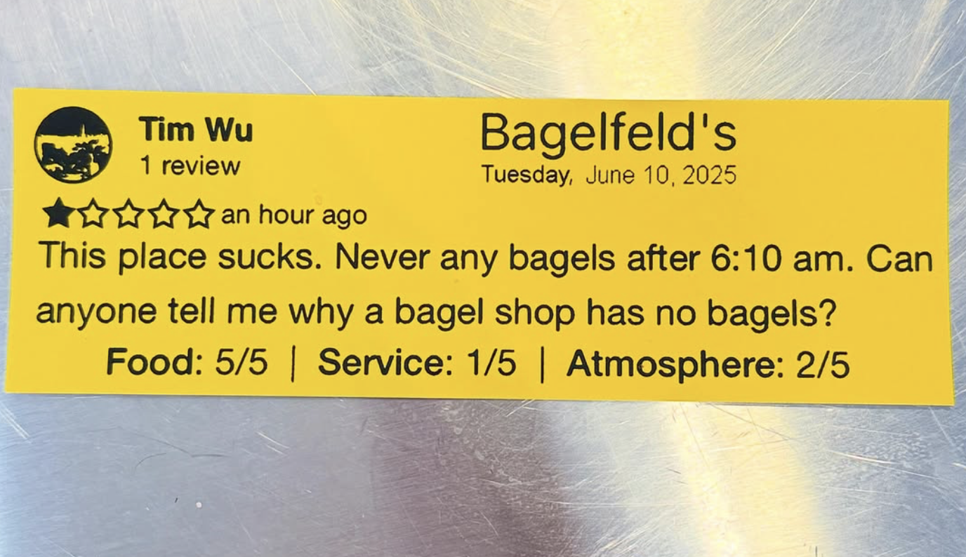 a yellow paper that shows a one-star review of Bagelfeld's by a user named Tim Wu that says: 