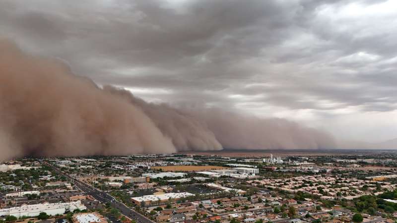 giant dust cloud rolling over a city