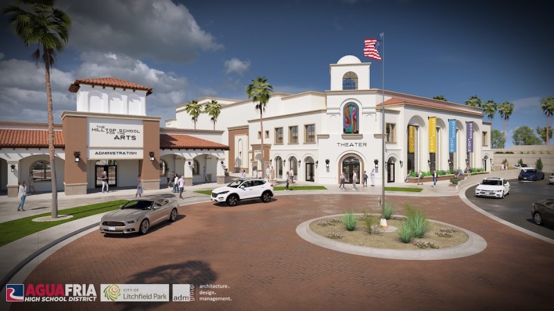 a school building next to a larger white building that says theater on it
