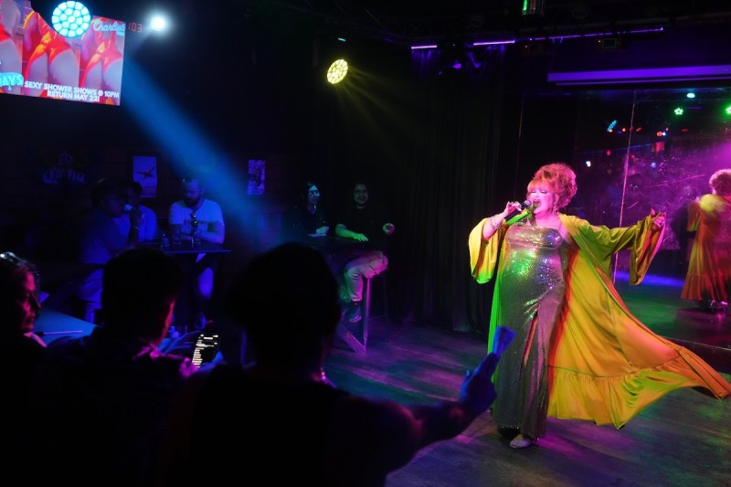 drag performer singing on stage