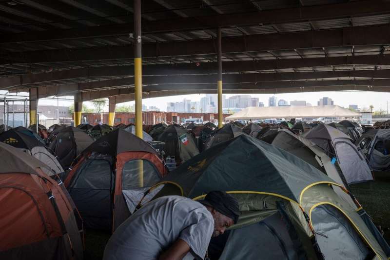 many rows of tents outside under a roof