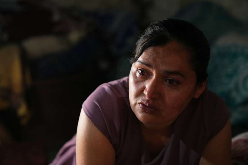 woman crying in a dark room