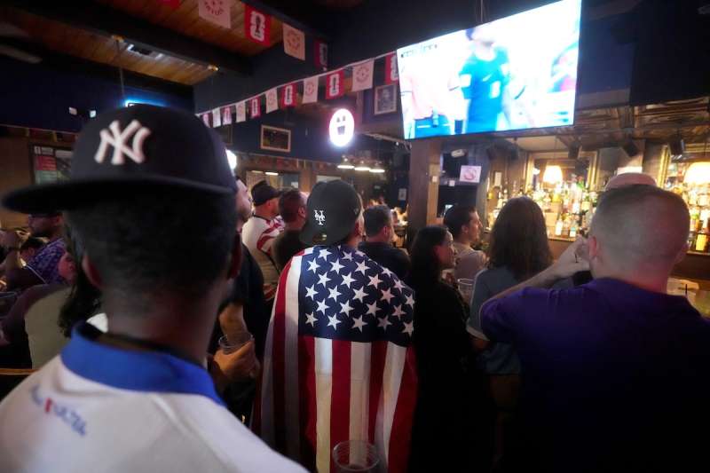 people watching soccer on tv at a bar