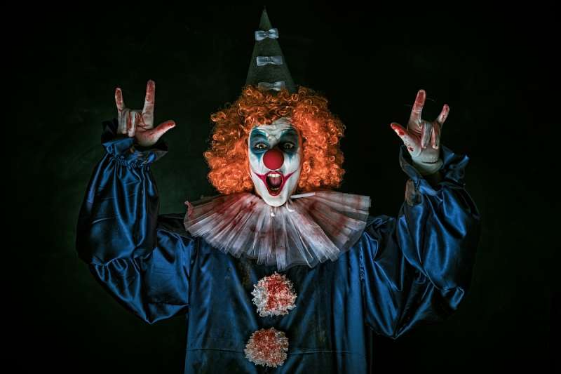 person dressed in a scary clown costume