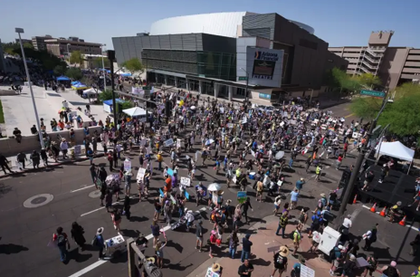 aerial shot of a large group of protesters in a street