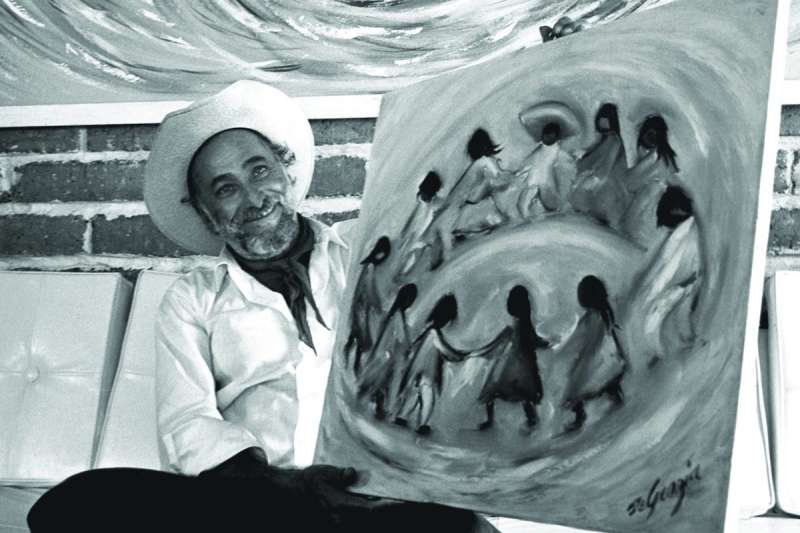 man holding a painting